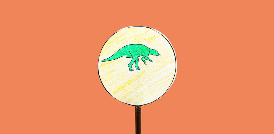 Dinosaur thaumatrope craft against orange background