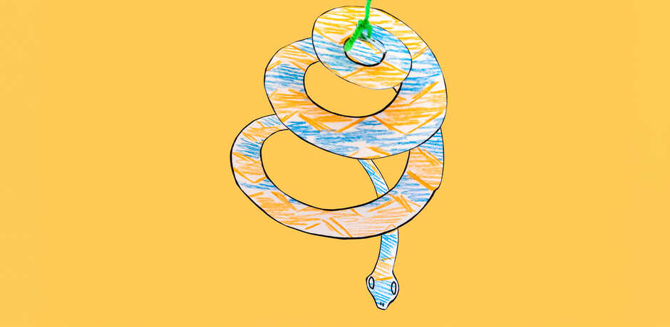 Paper snake mobile craft against yellow background