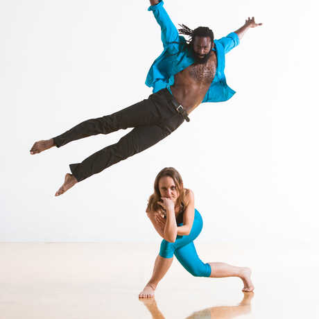 woman and man in blue and black and dancing