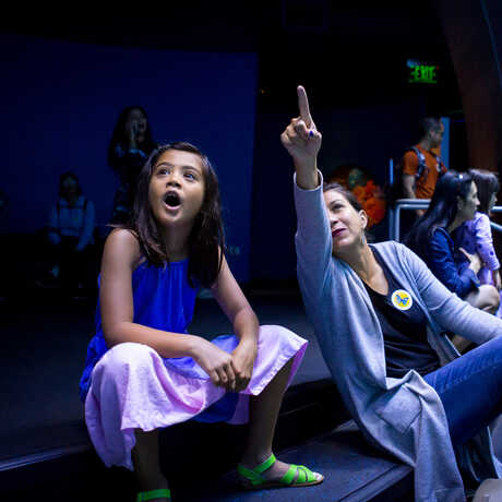 A woman shows an amazed young girl the Philippine Coral Reef exhibit
