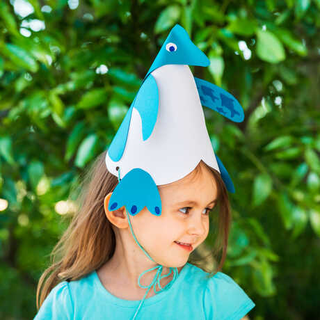 Girl wearing penguin party hat 