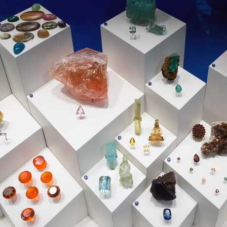 Assorted gems and minerals on pedestals in the exhibit