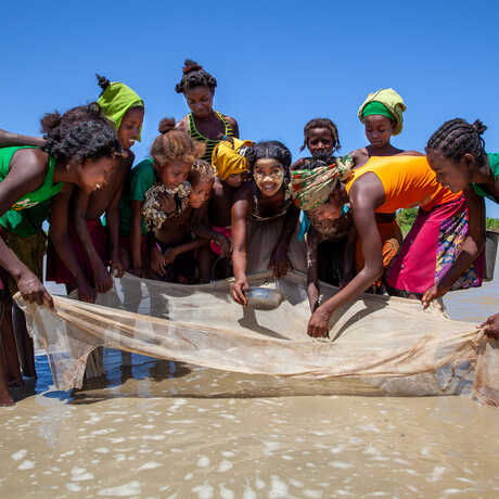 Madagascan girls pose with a fishing net