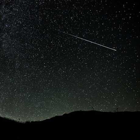 Meteor streaking across night sky