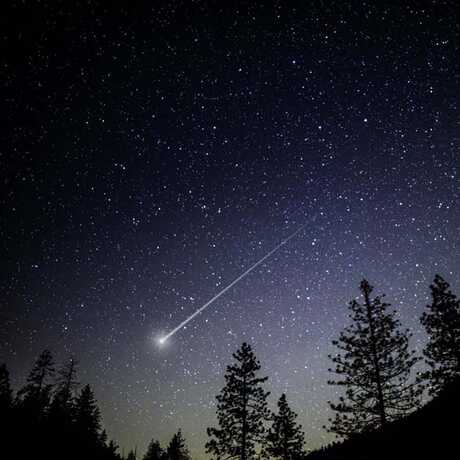 Meteor streaking across nigh sky