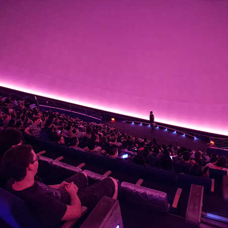 Interior of Morrison Planetarium with guests in audience, photo by John Hartsfield