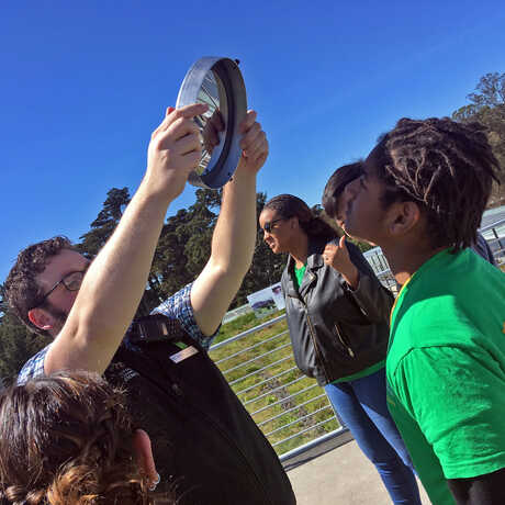 Academy educator demonstrates how telescopes work to students