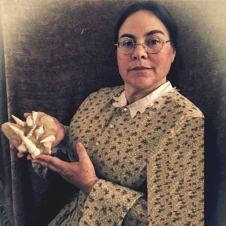 19th century paleontologist Mary Anning holding fossil shells