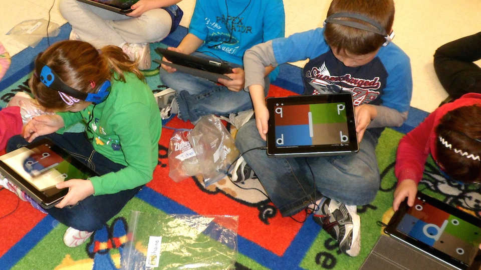 Students playing tablet game