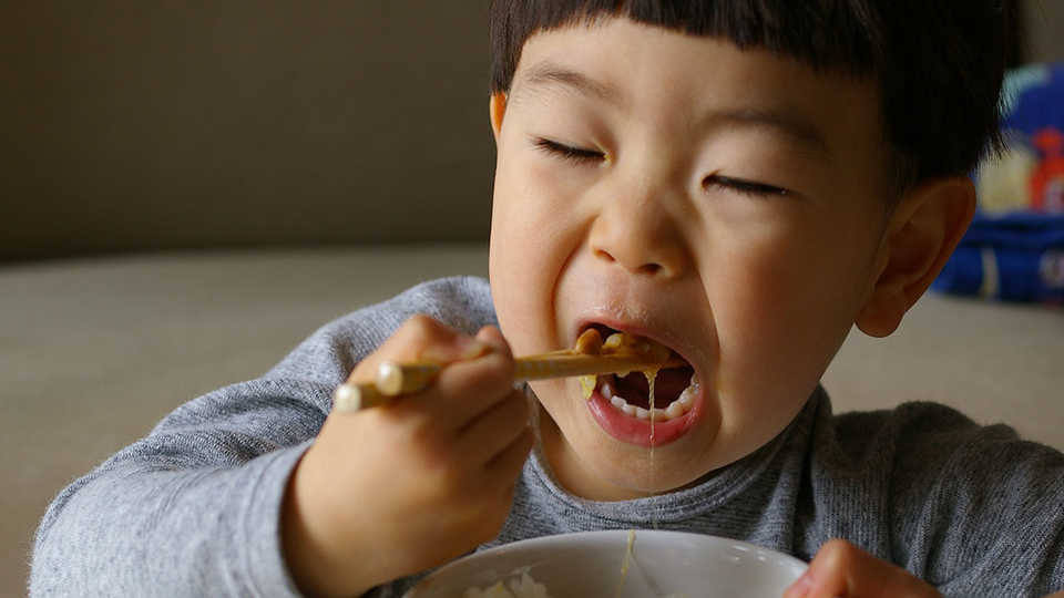 Child Eating with chopsticks