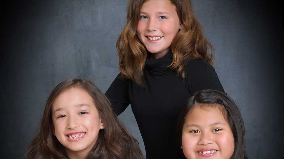 Three young girls ready to sing seasonal songs